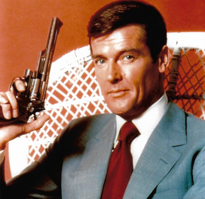 Roger Moore - Autographed Photo James Bond 007 in classic Bond pose with gun b'bc COA.