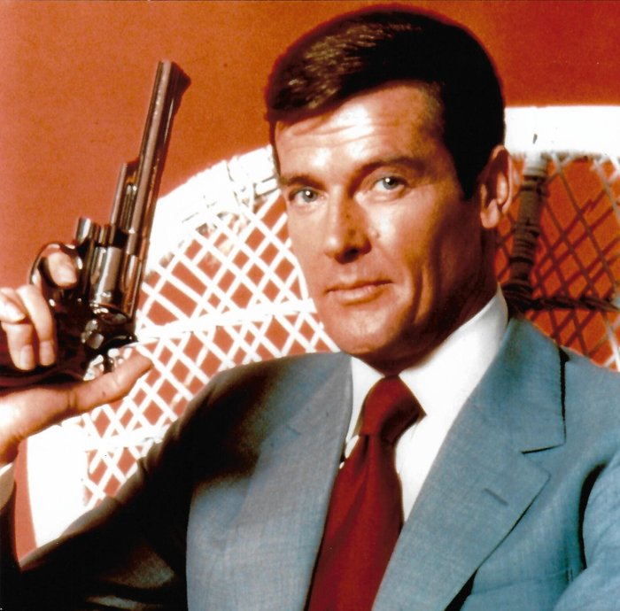 Roger Moore - Autographed Photo James Bond 007 in classic Bond pose with gun b'bc COA.