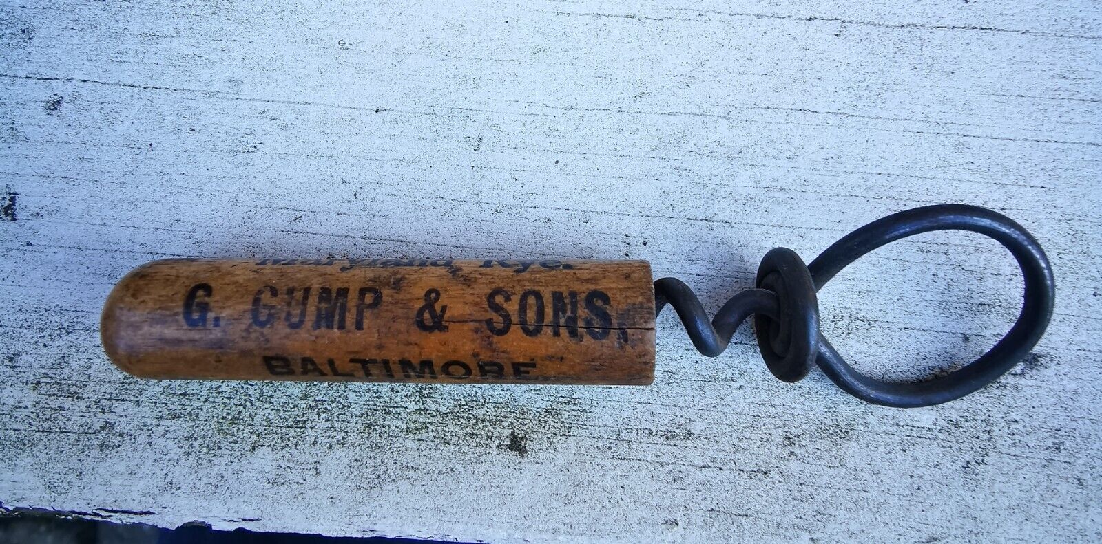 G Gump  Son Whiskey Baltimore metal corkscrew with wooden cap c 1910