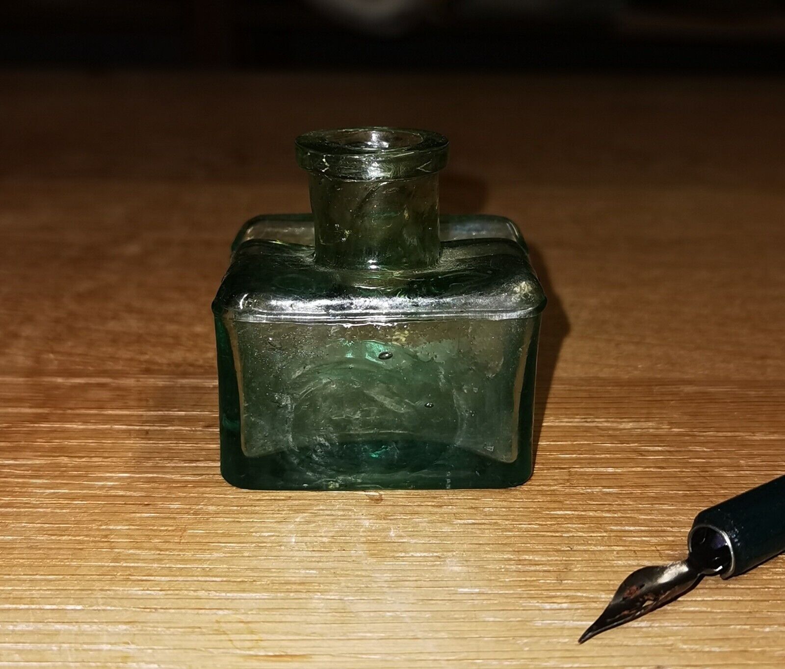 Antique green transparent ink well in glass from the late 19th century