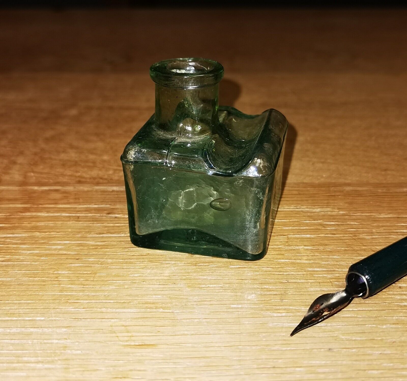 Antique green transparent ink well in glass from the late 19th century