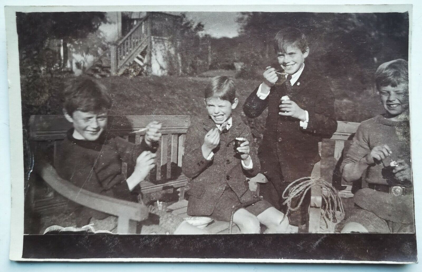 Photo postcard:  Four young smiling boy´s eating hard boiled egg 1920s  pok1384