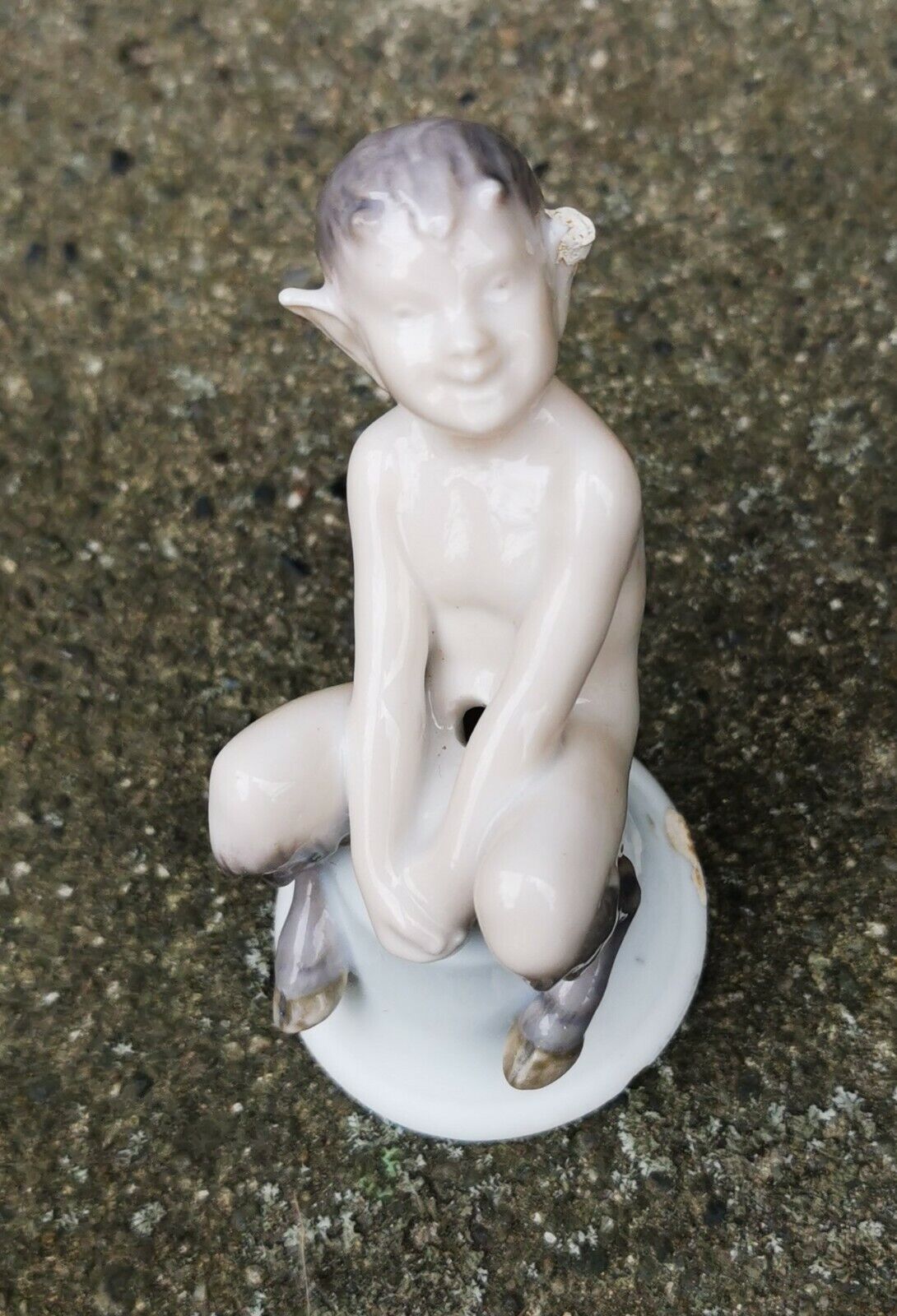 Early rare Royal Copenhagen Pan porcelain figure sitting on a bell 1900-1923