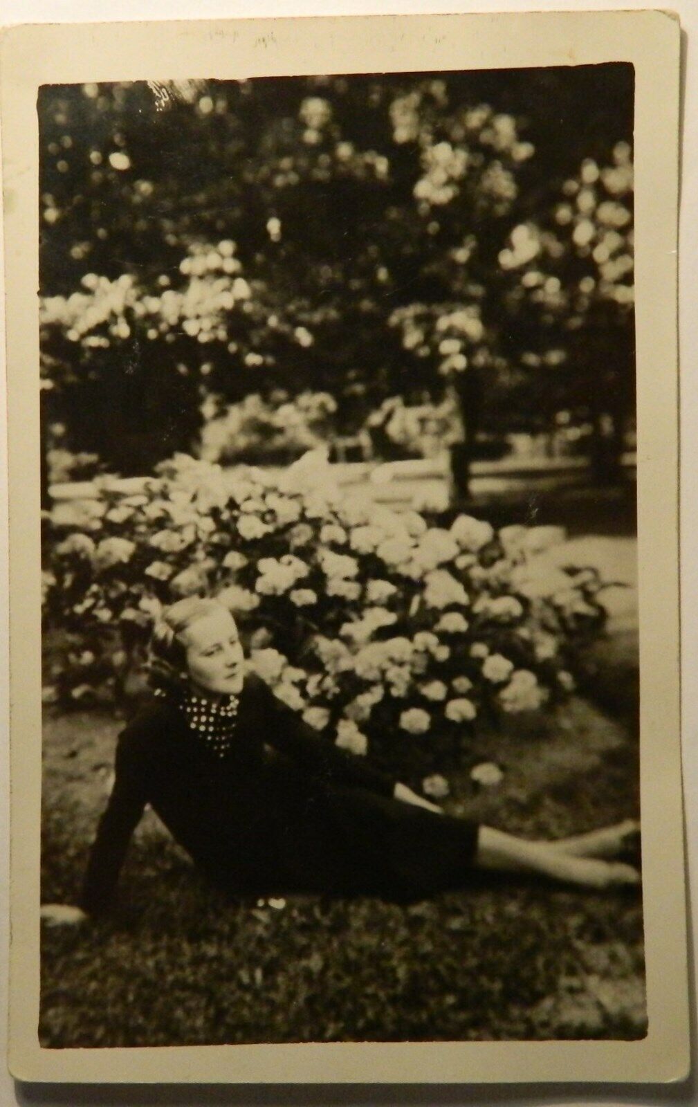 Vtg postcard: Mysterious sad young blonde woman sitting in the grass  pok1186