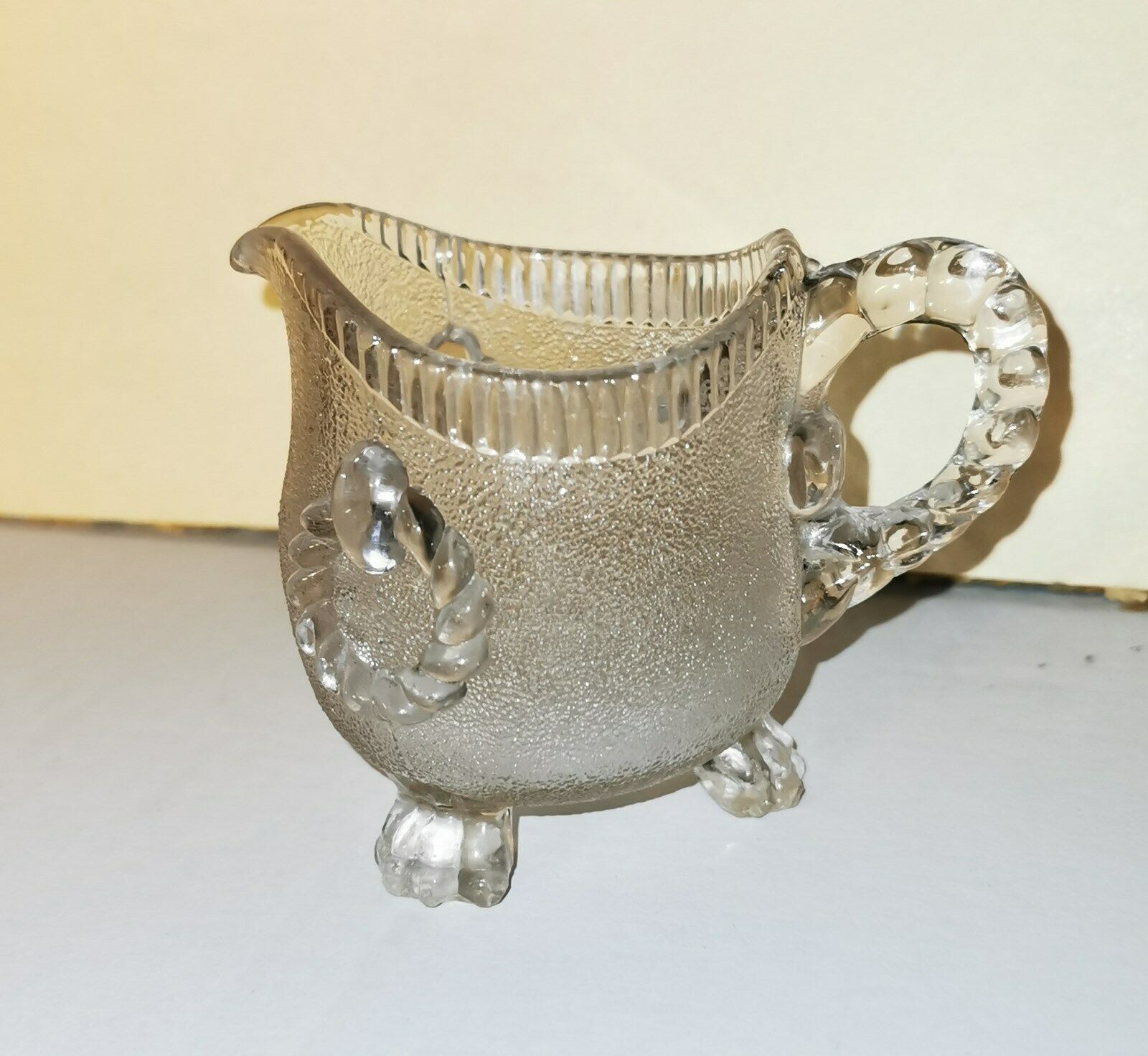 Charming antique pressed glass creamer pitcher on three feet from U K c 1900