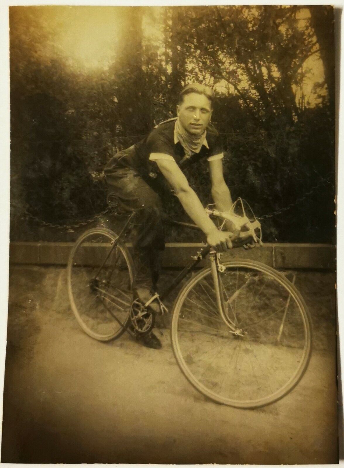 Vintage photo: Portrait of young man sitting on his new racer bicycle  Fy020