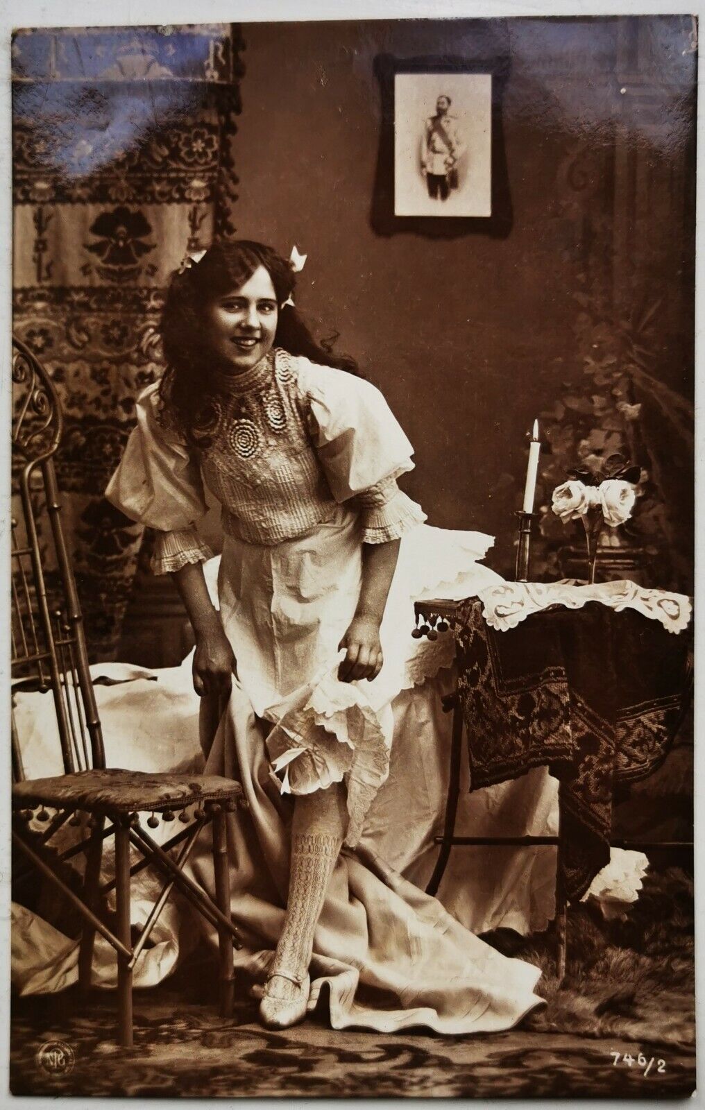 Old photo postcard: Cute smiling young woman in her bed room c 1910  pok1282