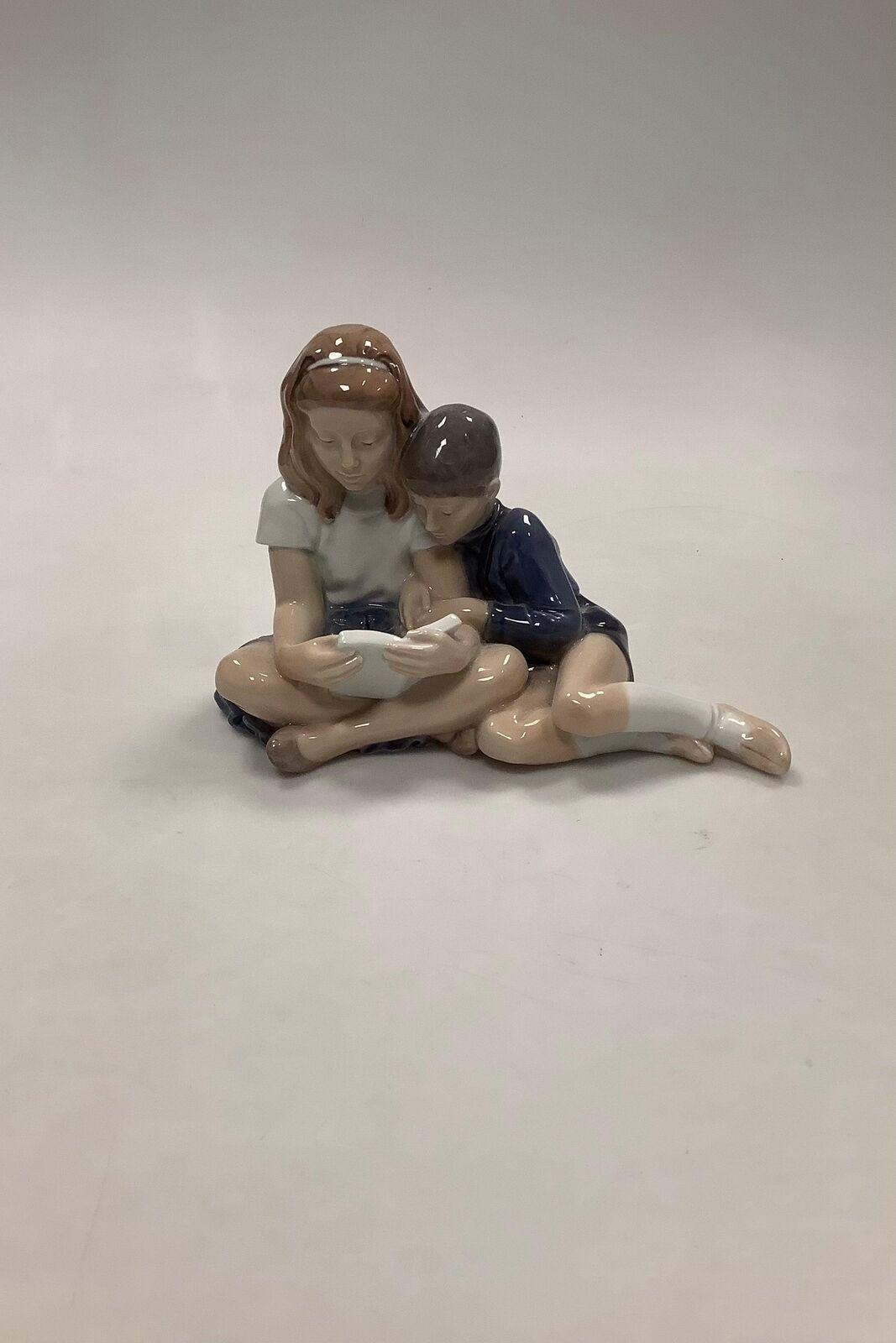 Royal Copenhagen Figurine of sitting Boy and Girl No 4670