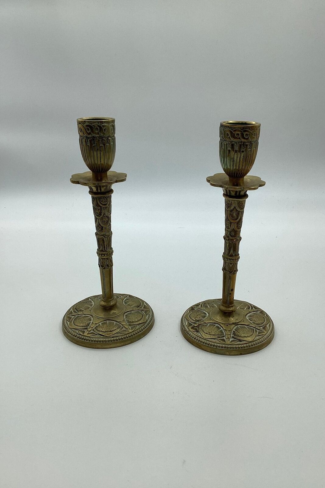 Pair of brass candlesticks with art deco decorations in relief ca 1920