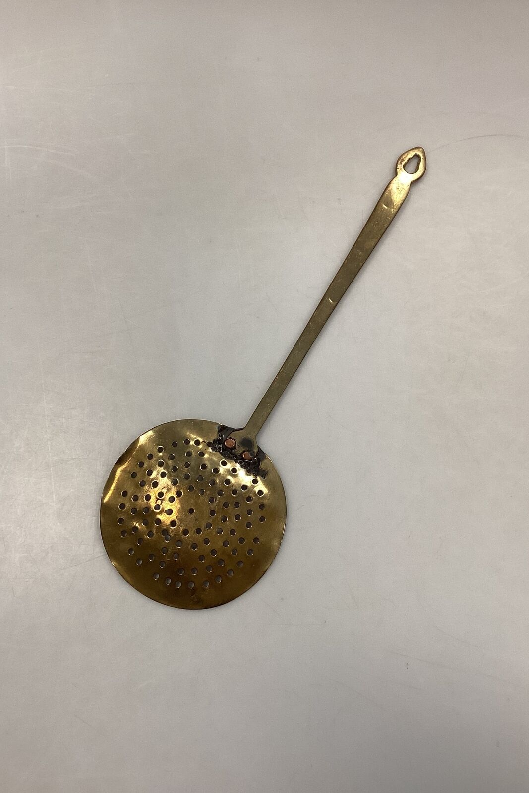 Antique hollow spoon in brass