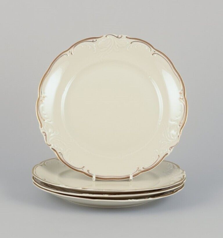 KPM Poland A set of four porcelain lunch plates Cream-colored with gold rim