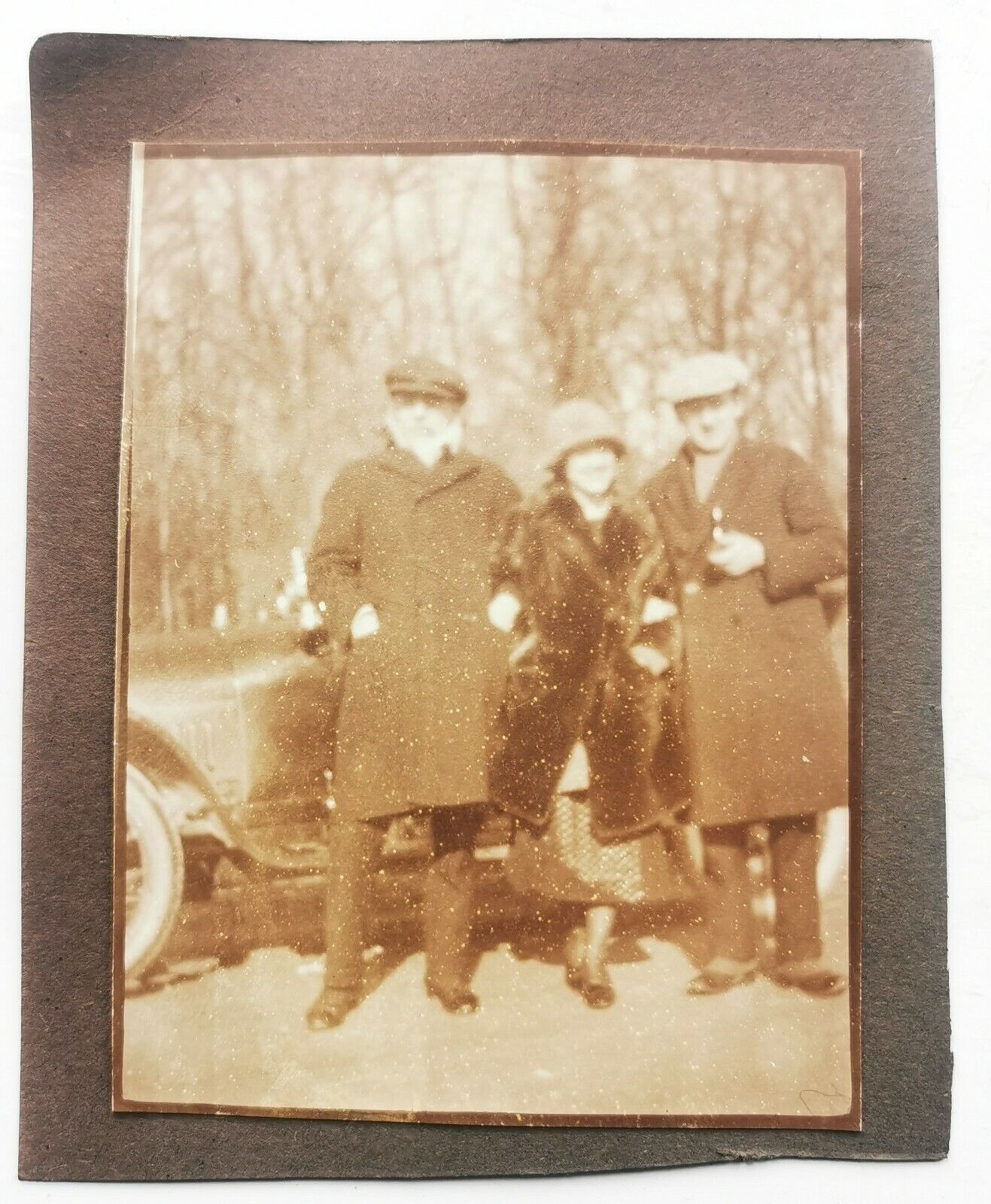 Old photo: Woman with hat and coat on stone field with stone in her hand  Fo584