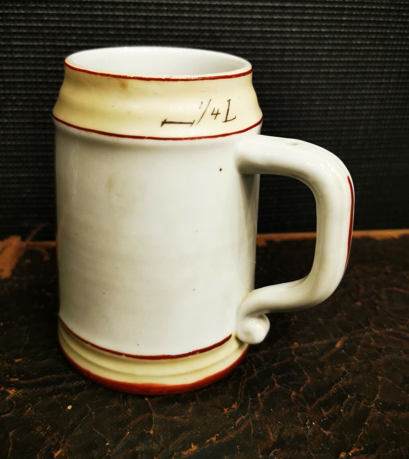 Smaller old porcelain beer mug with romatic scene outside and inside the bottom