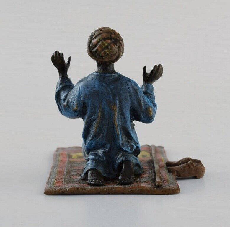 Antique cold-painted Vienna bronze shaped as praying man on a prayer mat