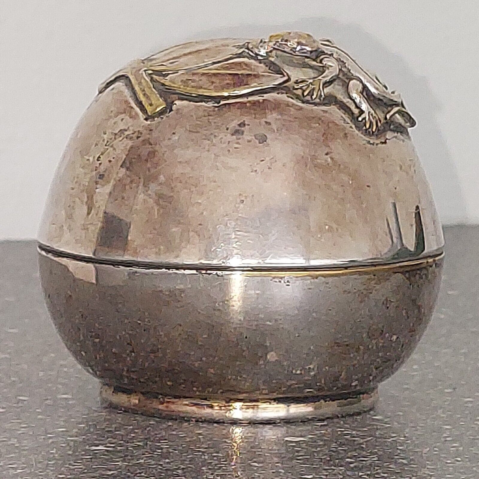 Small round silver plated  money bank with lizzard on top c 1930