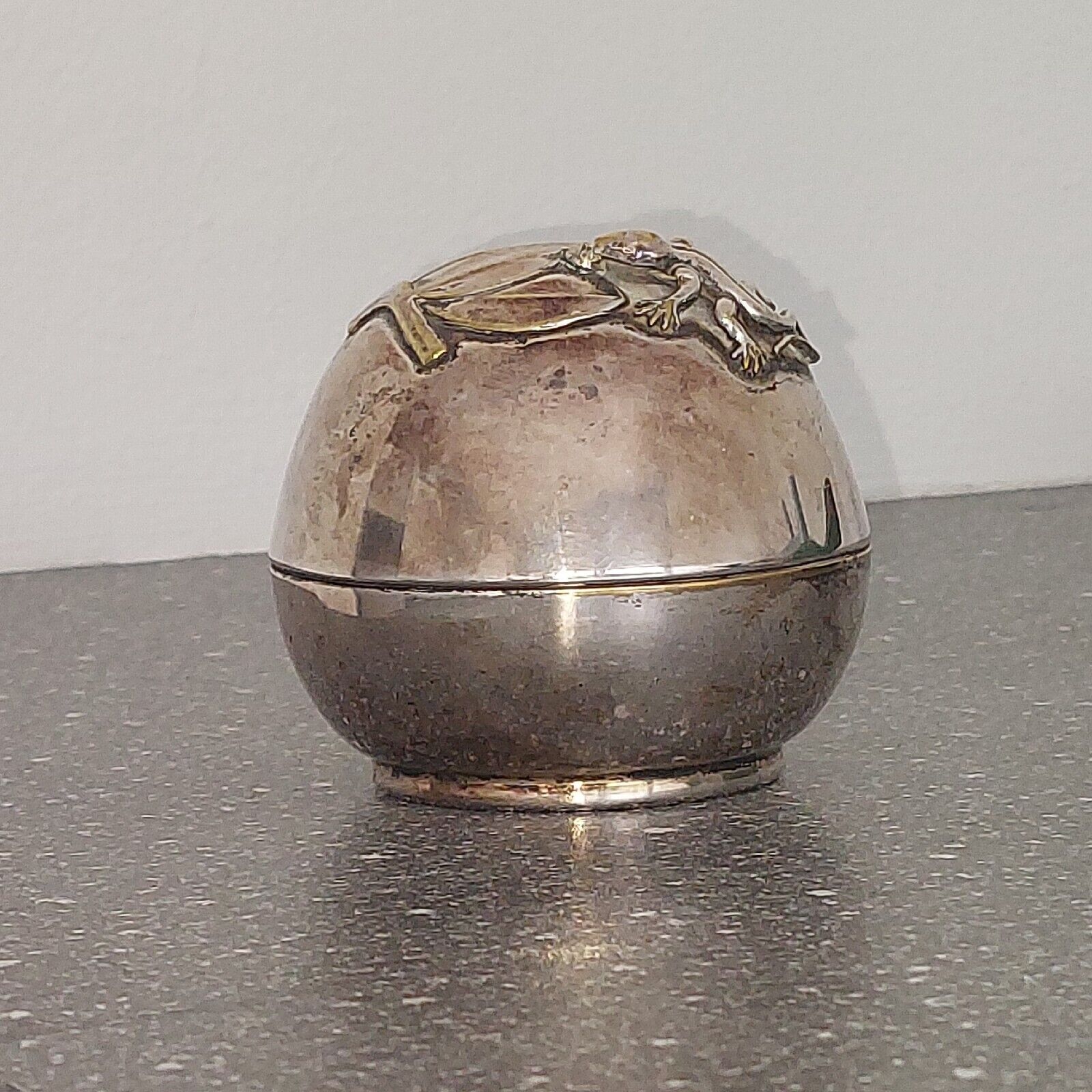 Small round silver plated  money bank with lizzard on top c 1930