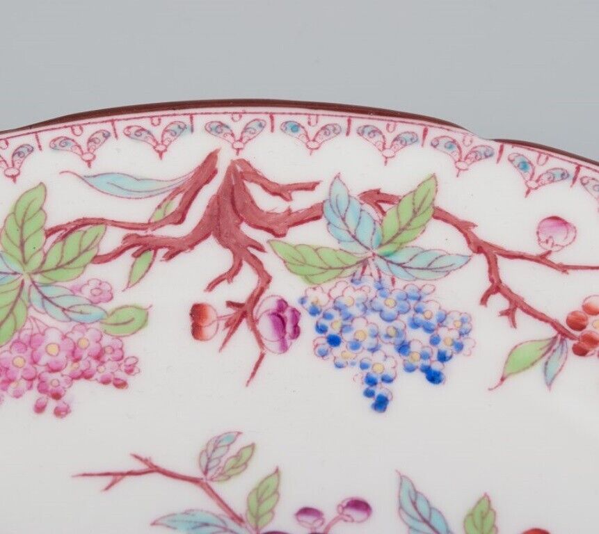 Sarreguemines France a set of six porcelain plates with floral motifs