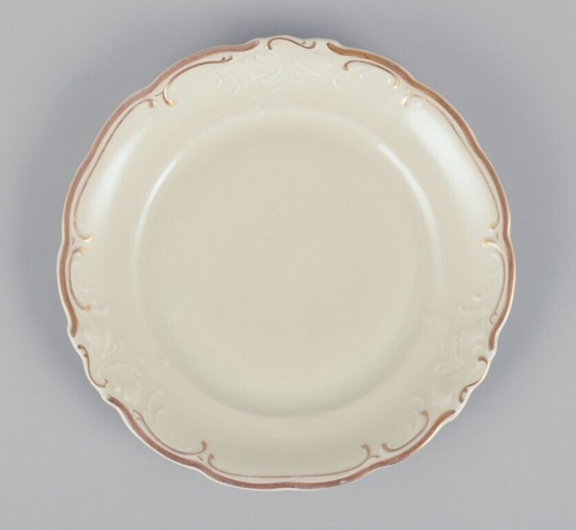 KPM Poland A set of ten cream-colored porcelain plates with gold decoration