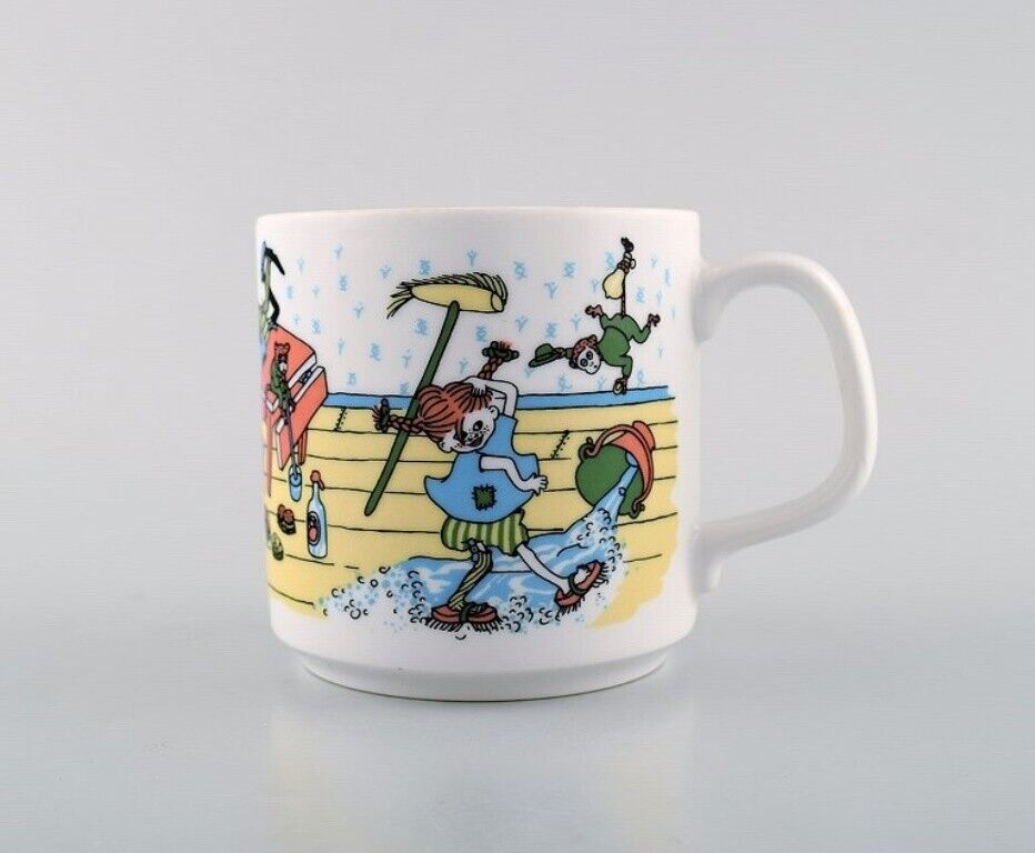 Rörstrand Four cups and a plate in porcelain with Pippi Longstocking motifs