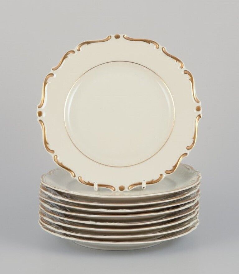 KPM Poland Nine cream-colored porcelain plates with gold decoration