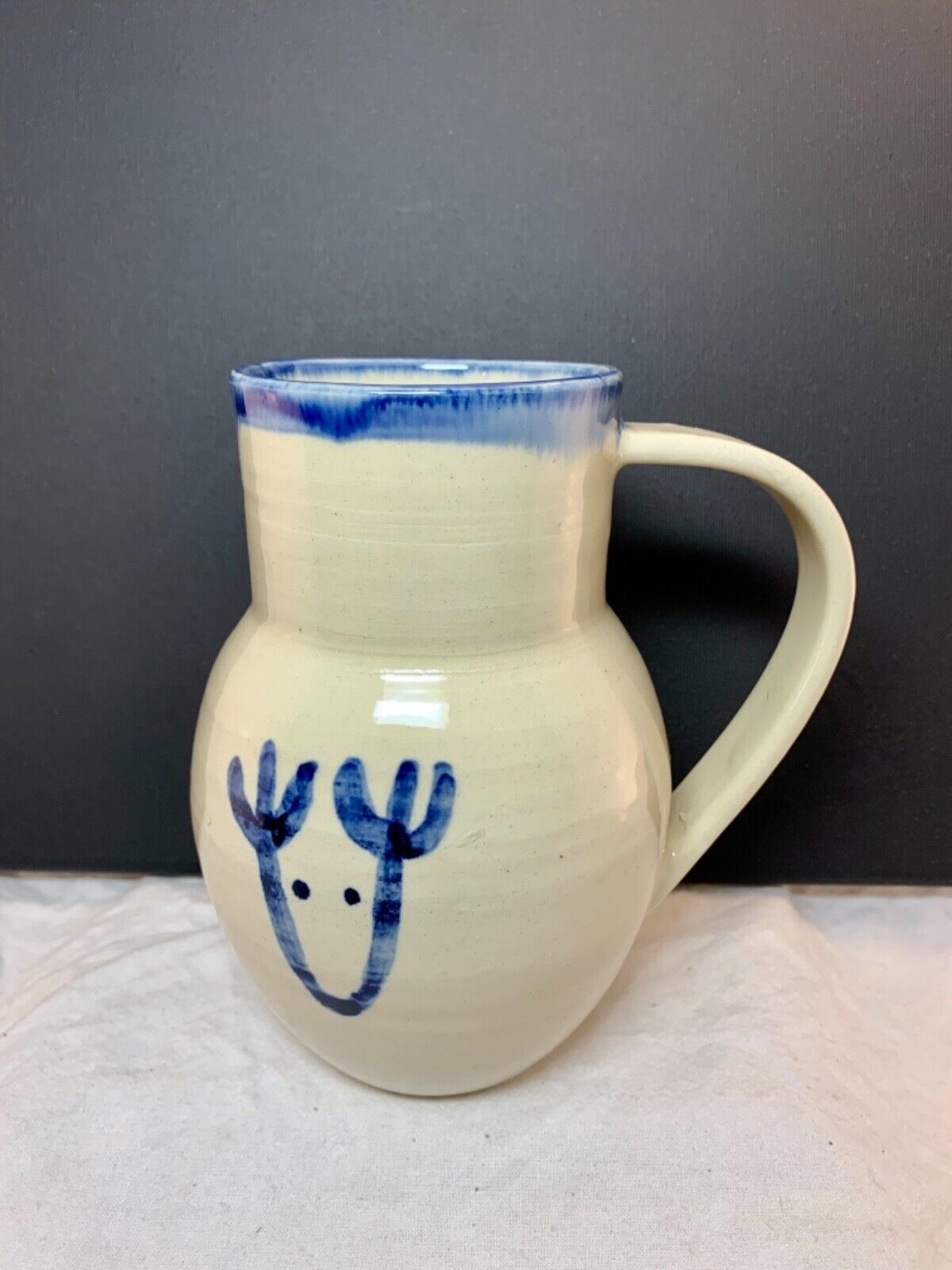 Studio pottery white jug vase with cobalt blue reindeer sketch signed 16x13cm