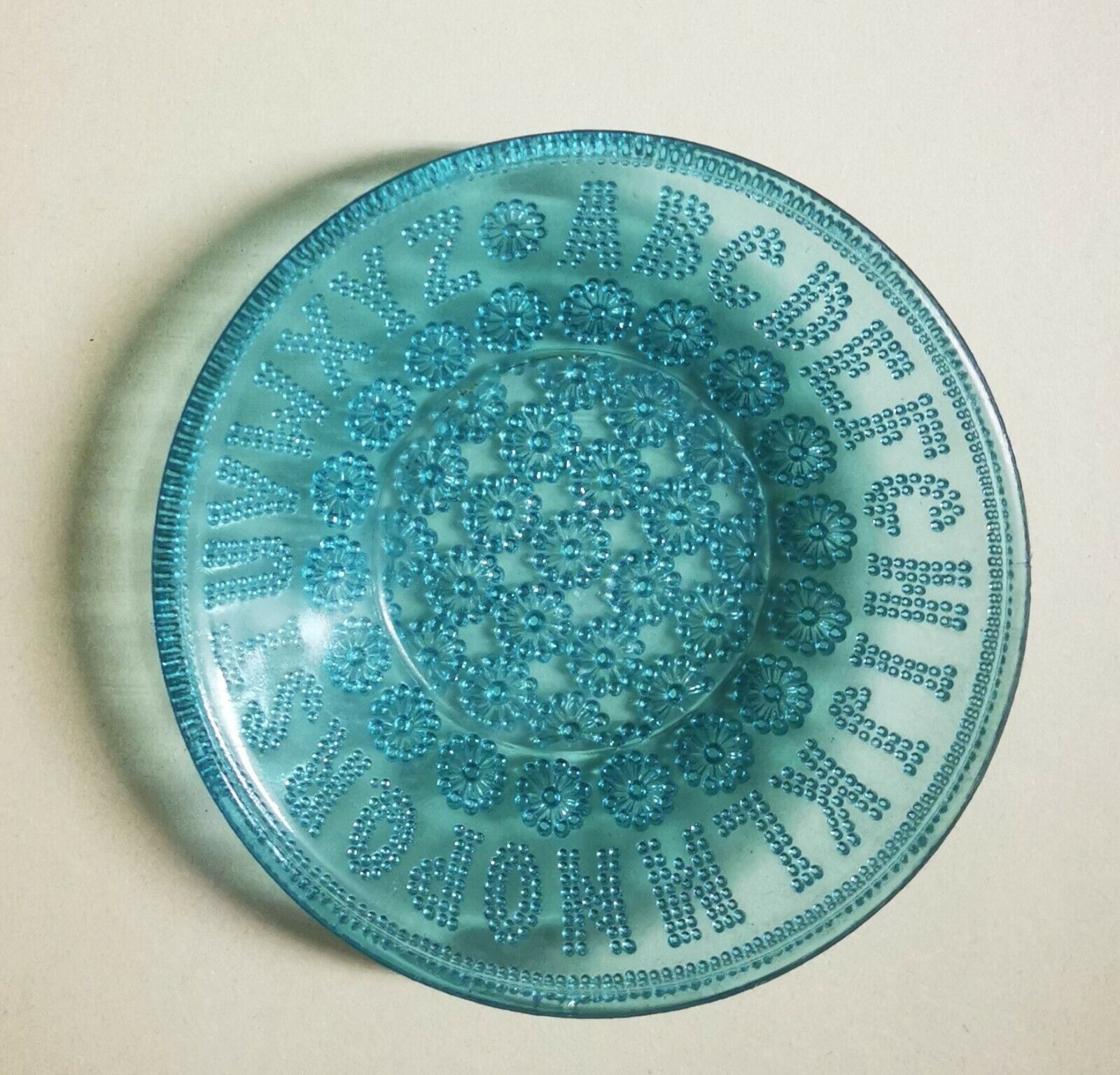 Antique pressed coloured smaller plate with letter decorations from around 1900