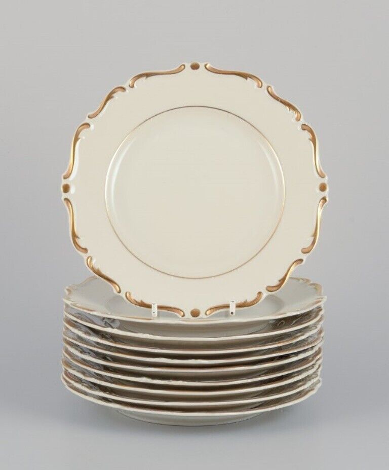 KPM Poland A set of ten cream-colored porcelain plates with gold decoration