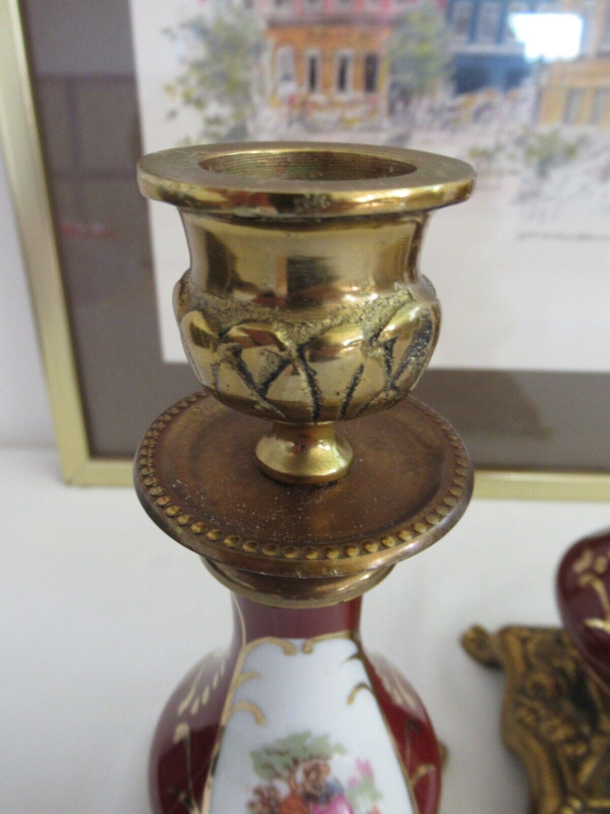 Vintage pair of candle holders in brass and porcelain with a romantic scene