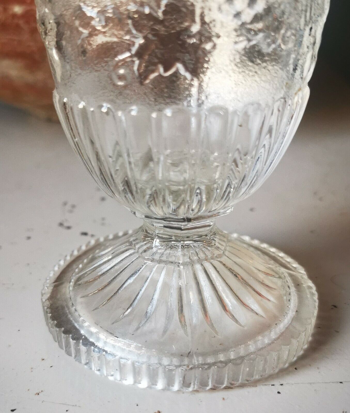 Antique pressed drinking glass with grape and bird decorations from c 1900