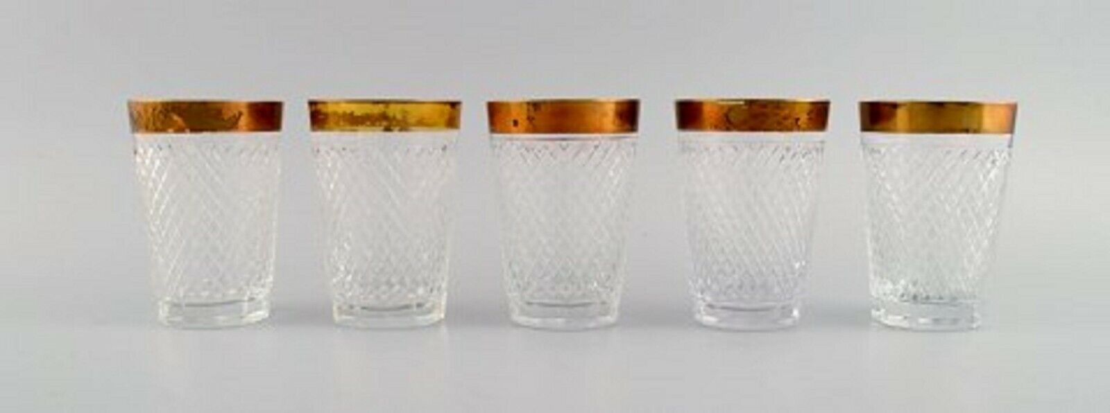 Seven drinking glasses in mouth-blown crystal glass with gold edge France 1930s