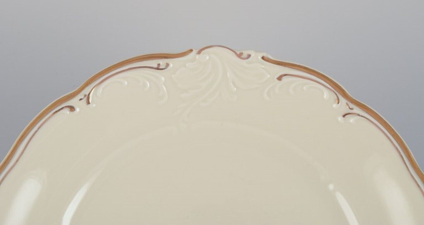 KPM Poland A set of six porcelain lunch plates Cream-colored with gold rim