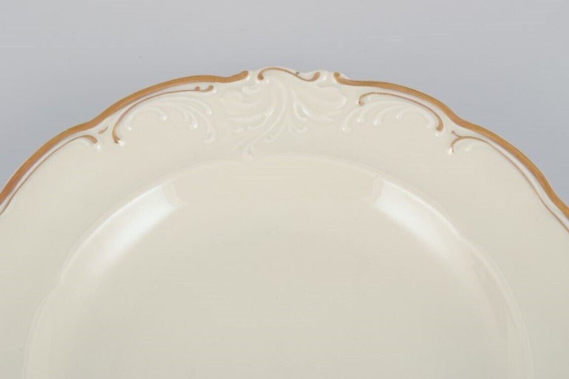 KPM Poland Four large deep porcelain plates in cream color with gold rim