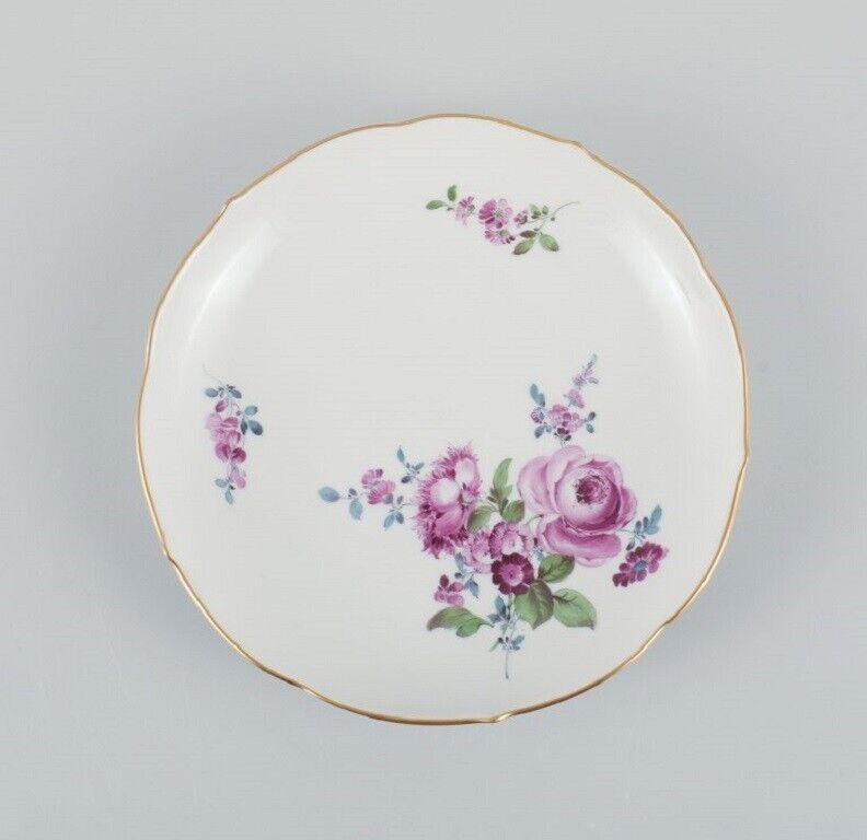 Six antique Meissen plates hand painted with polychrome flowers and gold edge