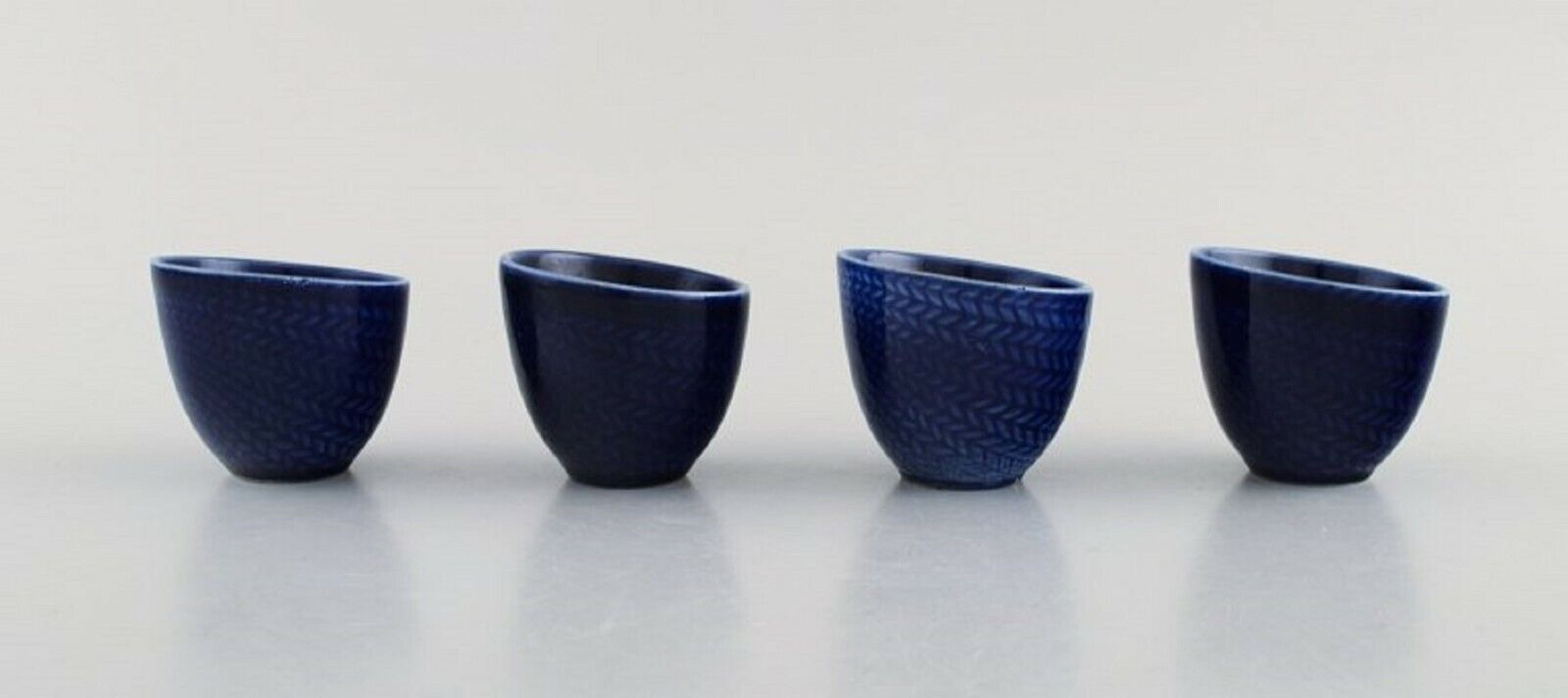 Hertha Bengtson for Rörstrand Four "blå eld" porcelain egg cups 1960's