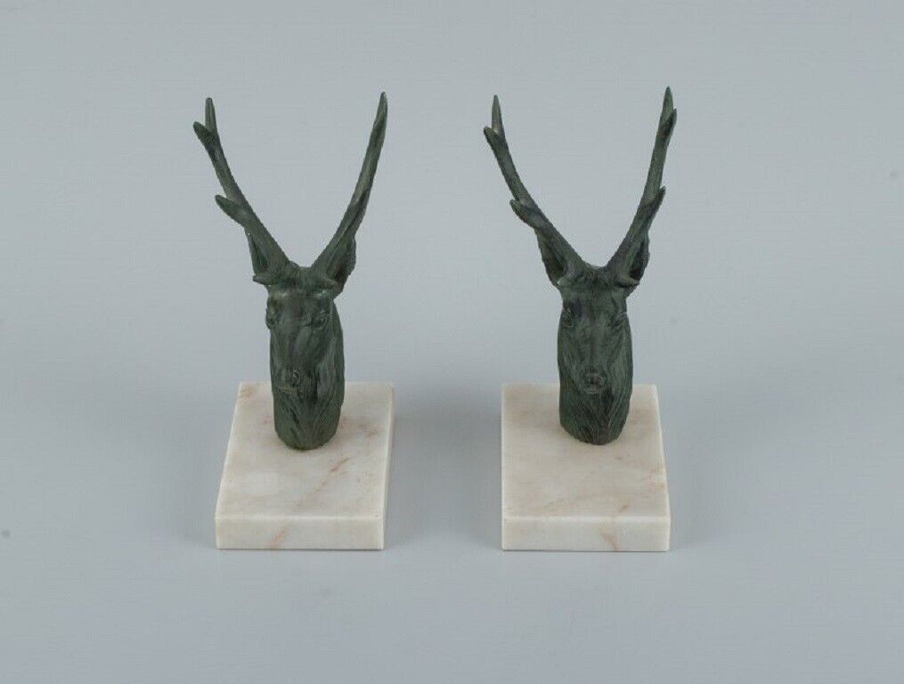 A pair of French Art Deco bookends Stags in patinated metal on a marble base