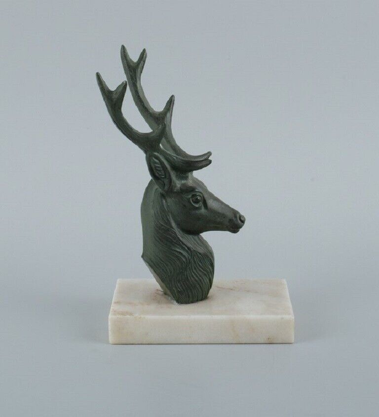 A pair of French Art Deco bookends Stags in patinated metal on a marble base