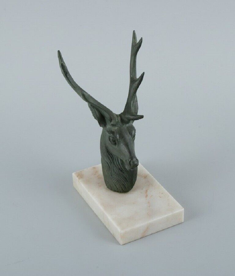 A pair of French Art Deco bookends Stags in patinated metal on a marble base