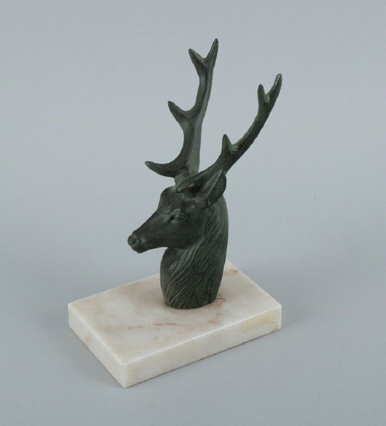 A pair of French Art Deco bookends Stags in patinated metal on a marble base