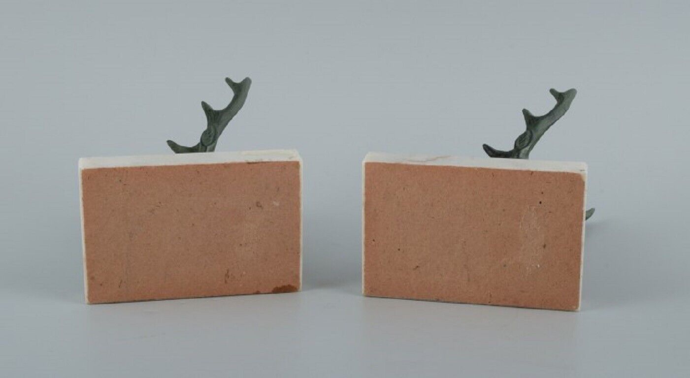 A pair of French Art Deco bookends Stags in patinated metal on a marble base