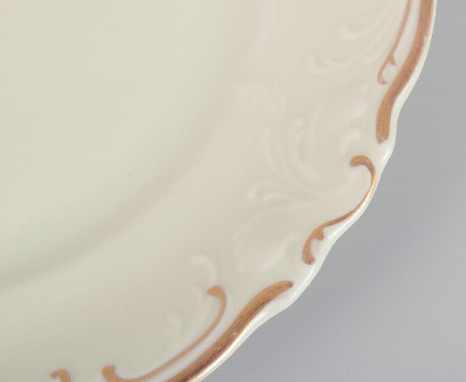 KPM Poland A set of ten cream-colored porcelain plates with gold decoration