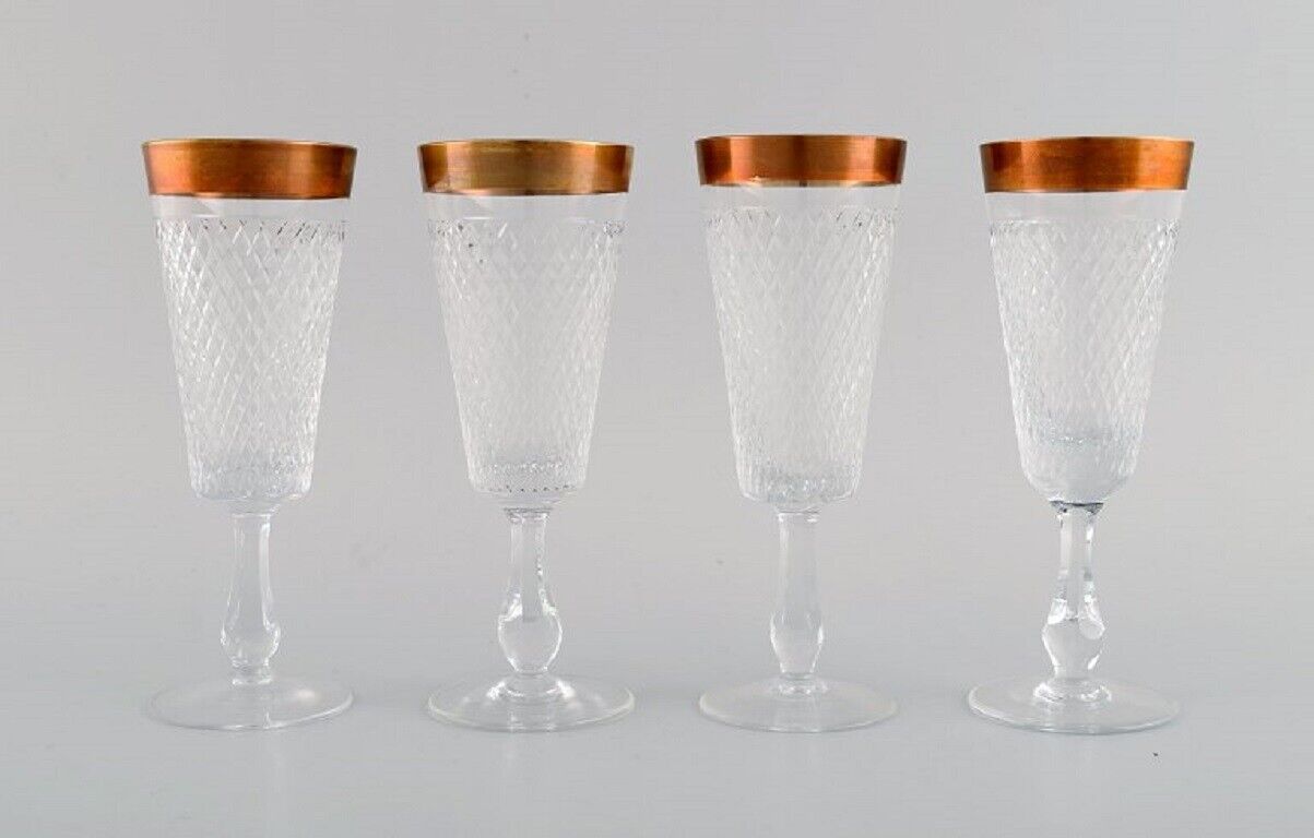 Four champagne glasses in mouth-blown crystal glass with gold edge France 1930s