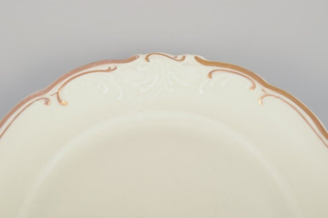 KPM Poland A set of ten cream-colored porcelain plates with gold decoration