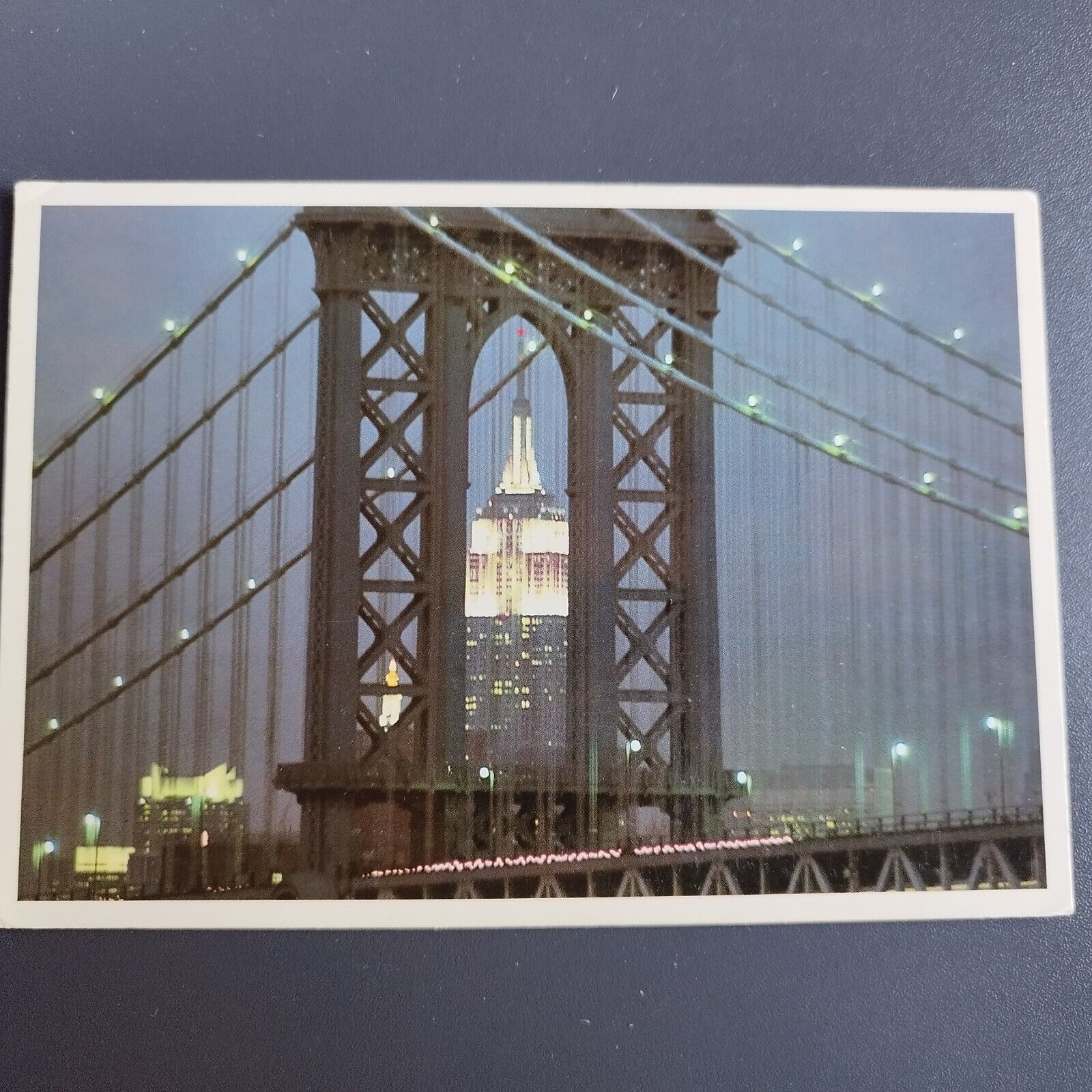 New York City Illuminated Empire State Building seen through Manhattan Bridge