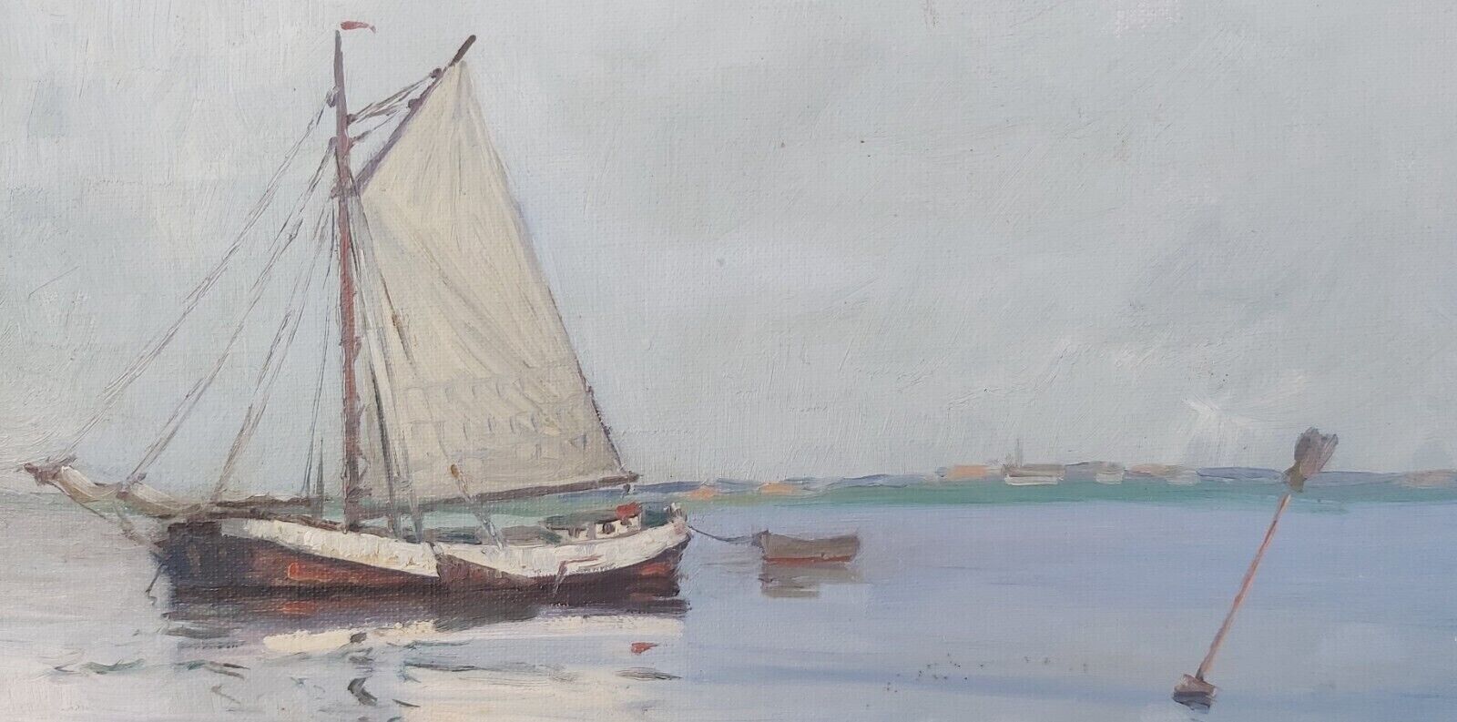 SMALL SAILBOAT FLOATS ON SEA