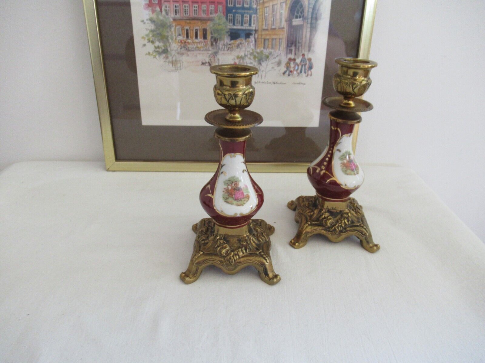 Vintage pair of candle holders in brass and porcelain with a romantic scene