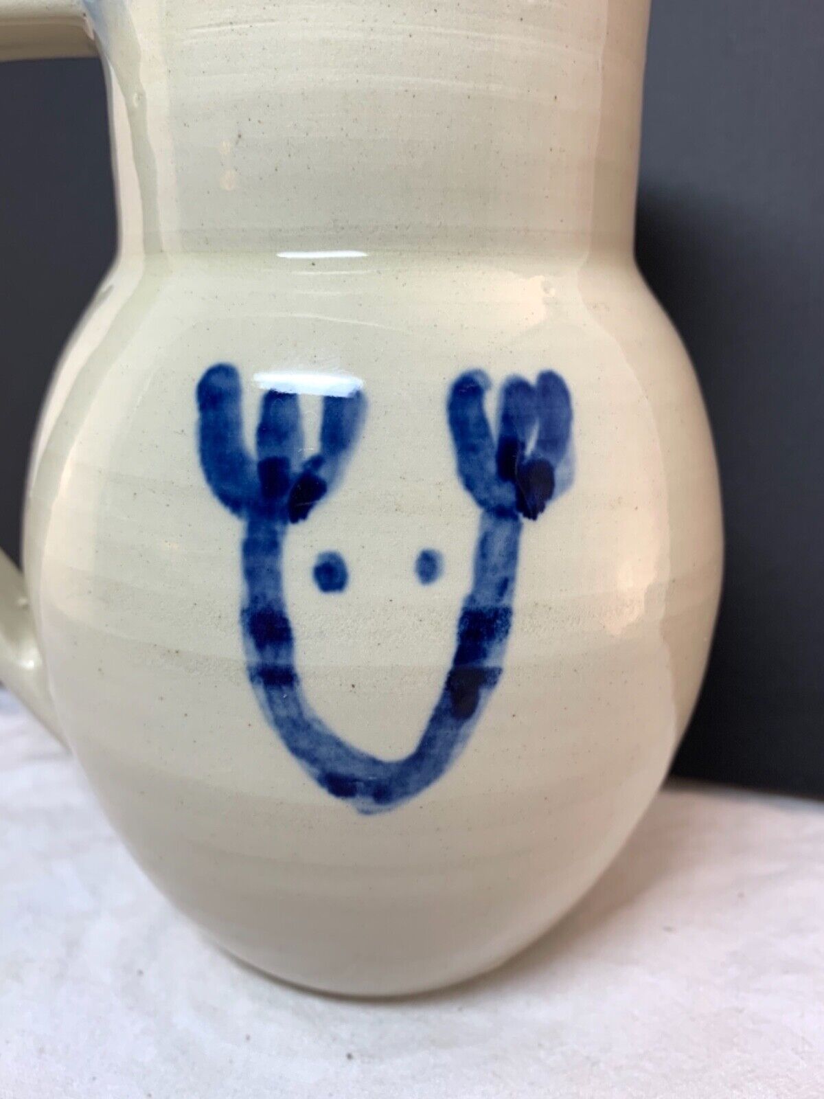 Studio pottery white jug vase with cobalt blue reindeer sketch signed 16x13cm