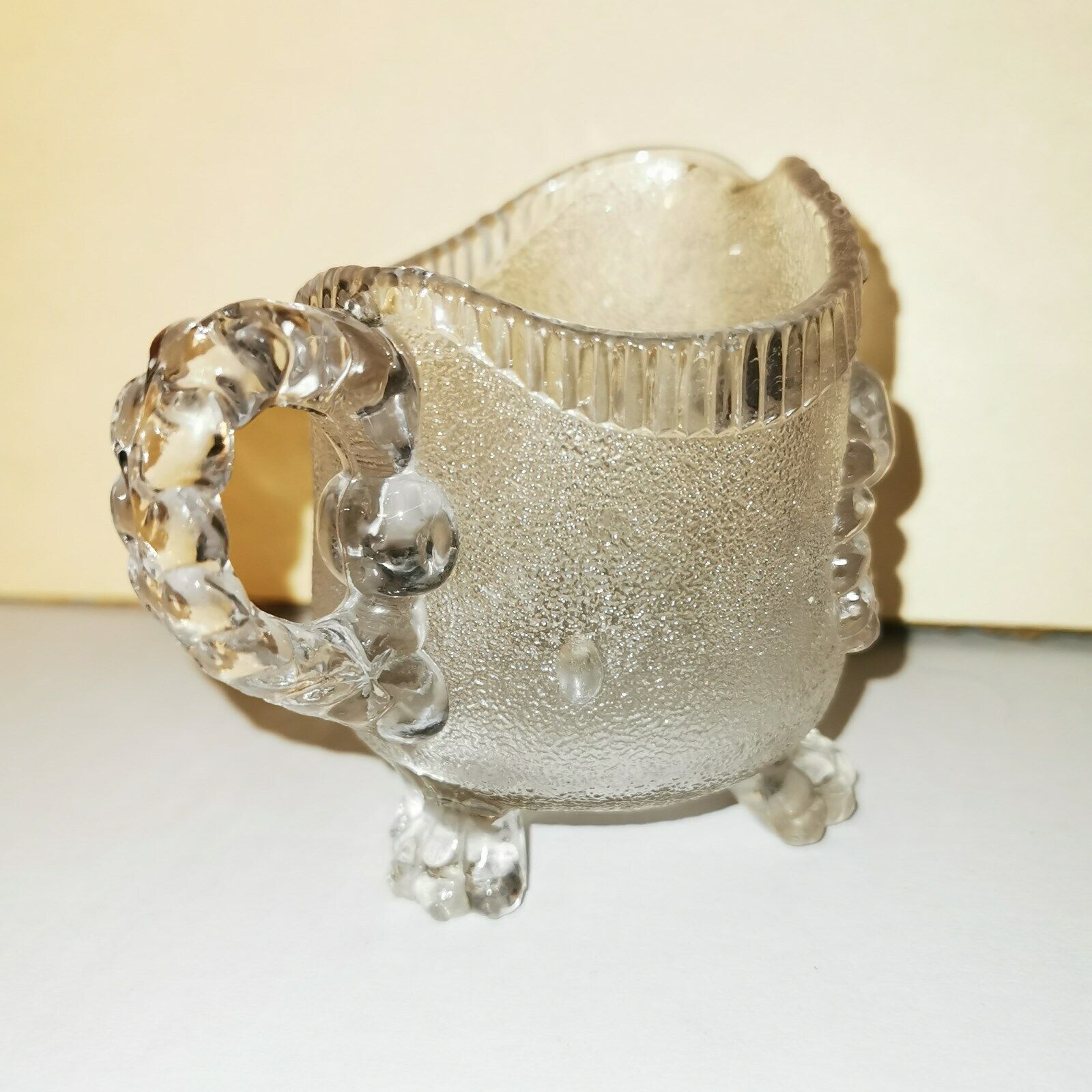 Charming antique pressed glass creamer pitcher on three feet from U K c 1900