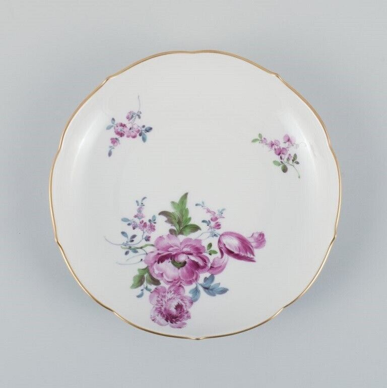 Six antique Meissen plates hand painted with polychrome flowers and gold edge