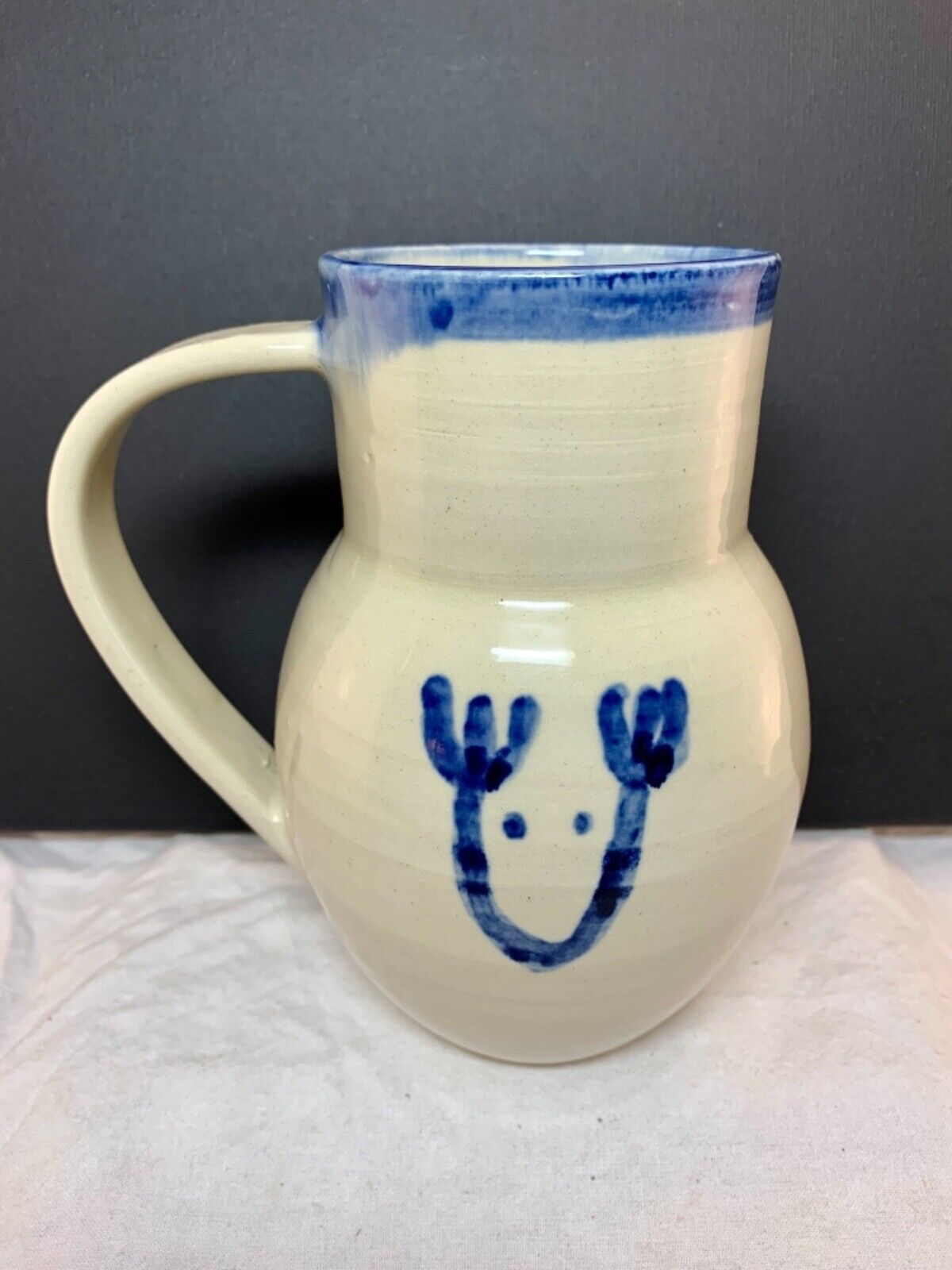 Studio pottery white jug vase with cobalt blue reindeer sketch signed 16x13cm