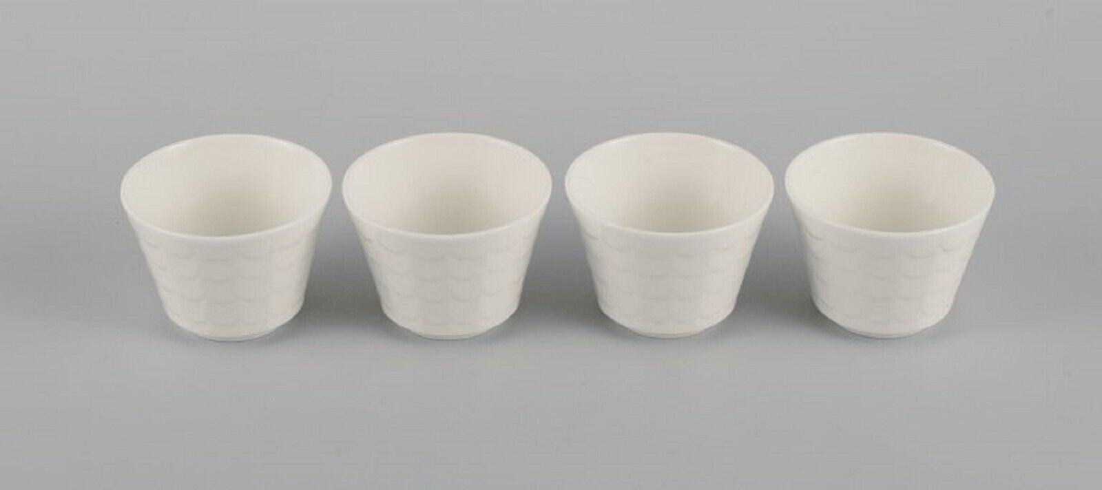 Wilhelm Kåge for Gustavsberg Four flower pot covers in porcelain